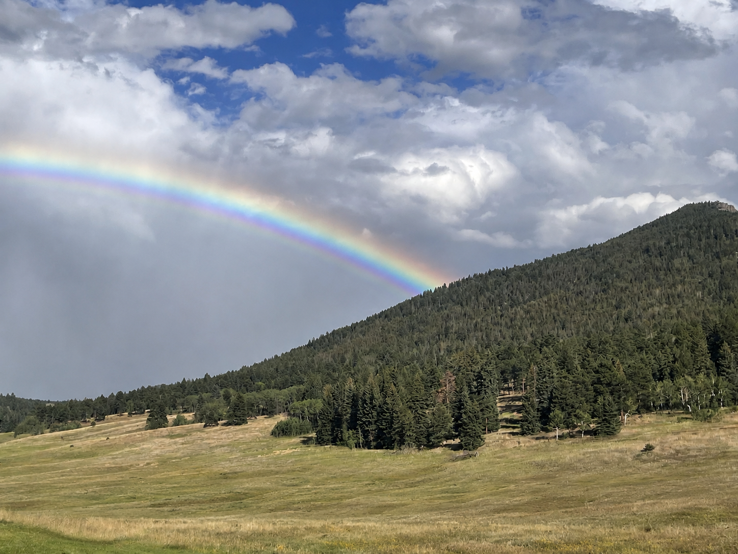 Rainbow arching over the Conifer mountain valley