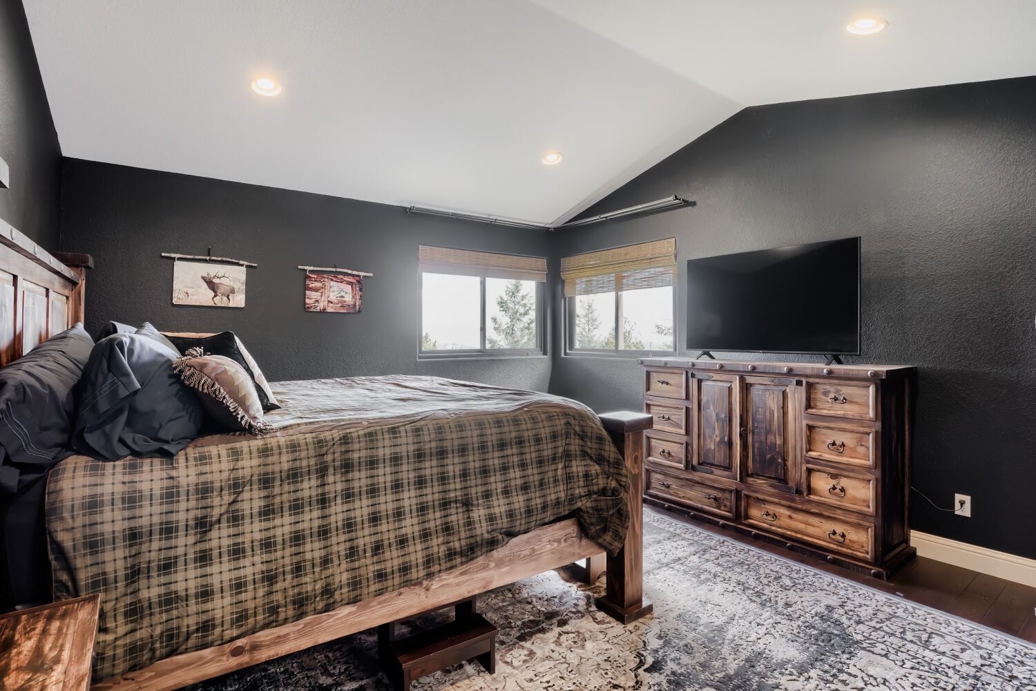 Primary bedroom with vaulted ceilings
