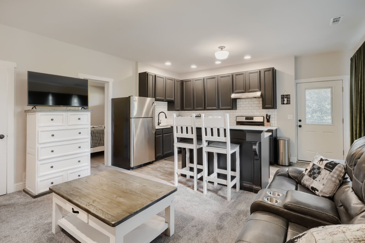 Kitchen with granite countertops, maple cabinetry, and stainless appliances